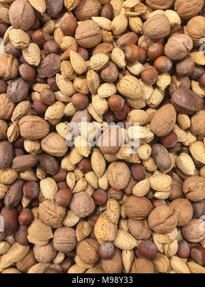 mixed nuts in their shells vertical background Stock Photo