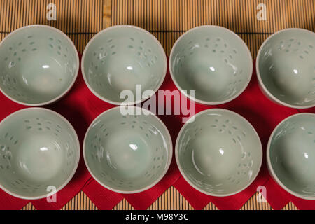 eight jade green Chinese tea cups on red paper napkins Stock Photo