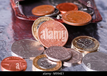 A small purse or change wallet in leather with coins inside Stock Photo