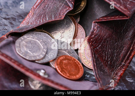 A small purse or change wallet in leather with coins inside Stock Photo