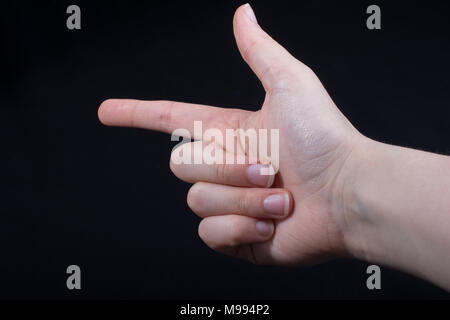 Hand gesture pointing fingers pistol-like handgun on black Stock Photo