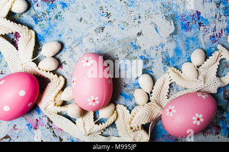 Colorful Ester eggs on hand painted blue background Stock Photo