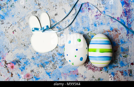 Colorful Ester eggs on hand painted blue background Stock Photo