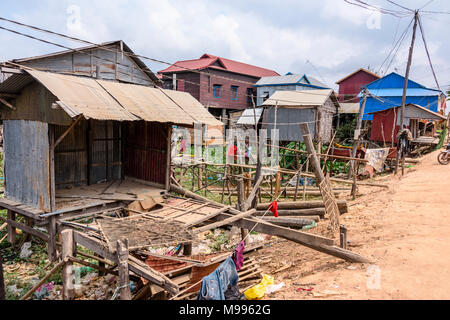 Houses in a poor, rural village with a dirt track road in Cambodia ...