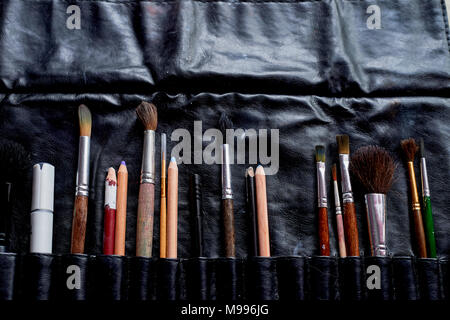 Brushes and pencils in a leather case.The artist's tools. Creativity and inspiration Stock Photo