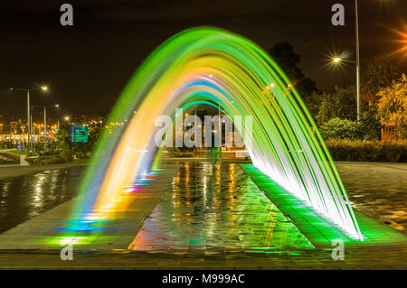 QUITO, ECUADOR- FEBRUARY 22, 2018: Beautiful outdoor view of colorful water entertainment structure fountain with buildings behind Stock Photo