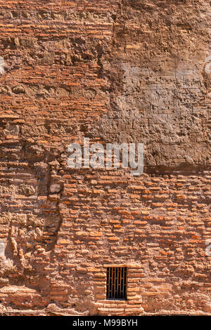 Wall texture of bricks and cement with markings and shadow definition with rusted rectangular metal vent in Rome Stock Photo