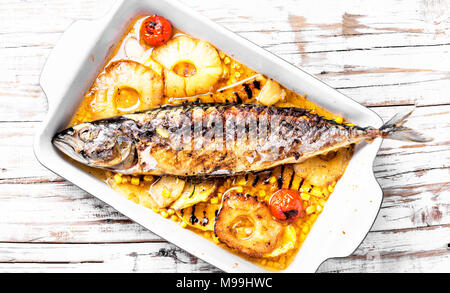 Roasted fish with pineapple and mango in pan Stock Photo