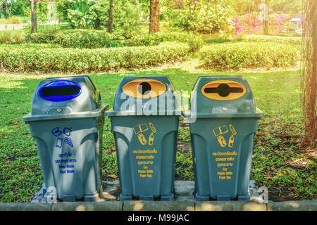 Plastic trash under the tree in the garden Stock Photo