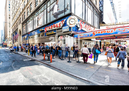 New York City, USA - October 28, 2017: Manhattan NYC buildings of midtown Times Square, Broadway street avenue road, sign, long line queue of people c Stock Photo
