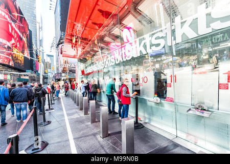 New York City, USA - October 28, 2017: Manhattan NYC buildings of midtown Times Square, Broadway avenue road, signs for ticket sales, many people buyi Stock Photo