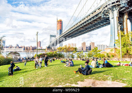 Brooklyn, USA - October 28, 2017: Dumbo outside exterior outdoors in NYC New York City, people in green, urban Main Street Park, cityscape skyline and Stock Photo