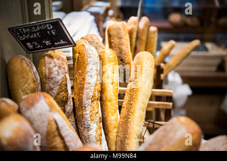 Closeup of fresh golden standard baked baguette loaves in bakery basket Stock Photo