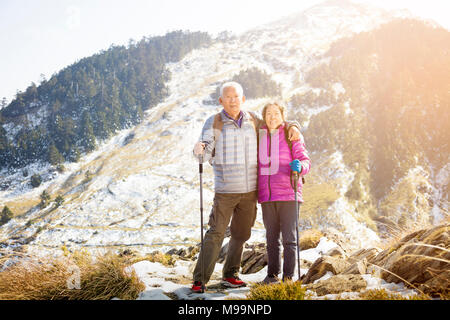 happy asian senior couple hiking on the mountain Stock Photo