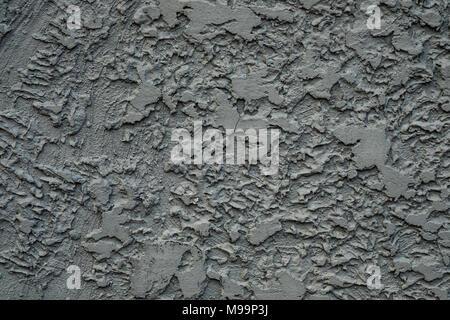 Stucco cement wall texture background in dark grey color paint. Stock Photo