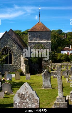 Village church and gravestones in the beautiful village of East Dean, Sussex, England, on a summer day Stock Photo