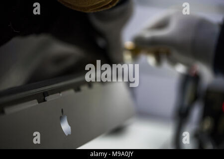 Reparing electronics devices, hands and tools, mobiles and computers. Mac reparing Stock Photo