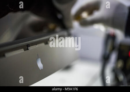 Reparing electronics devices, hands and tools, mobiles and computers. Mac reparing Stock Photo