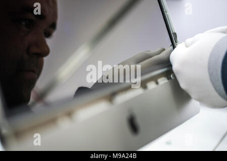 Reparing electronics devices, hands and tools, mobiles and computers. Mac reparing Stock Photo