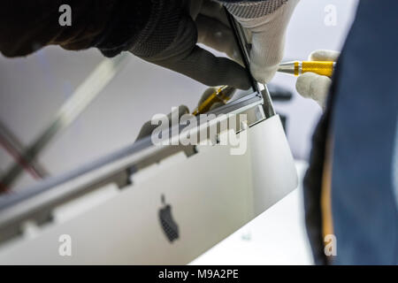 Reparing electronics devices, hands and tools, mobiles and computers. Mac reparing Stock Photo
