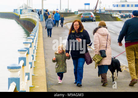 Weymouth, UK. 24th March, 2018. Families enjoy walking along Weymouth pleasure pier on a mild wind-free day Credit: stuart fretwell/Alamy Live News Stock Photo