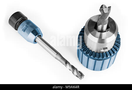 Spiral flute tap and end mill clamped in chuck on white background. Close-up of two decorative steel tools for threading or milling. Metalworking idea. Stock Photo