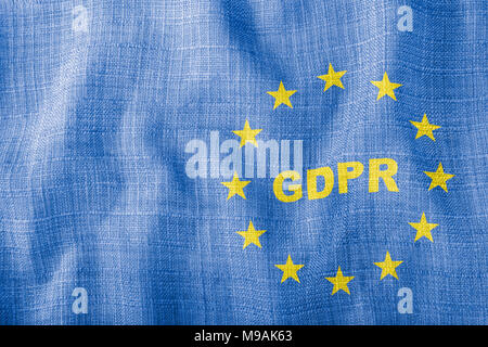GDPR letters with EU sign on blue wavy fabric. Texture with yellow stars of the European Union. Personal data protection, digitization and bureaucracy Stock Photo