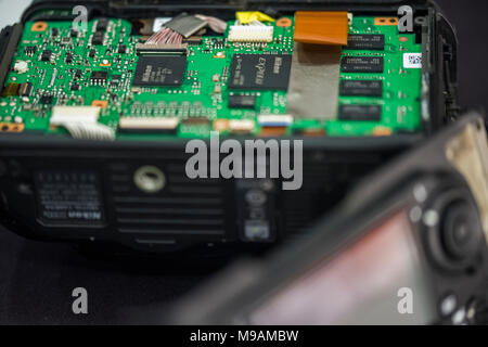 Reparing electronics devices, hands and tools, mobiles and computers. Nion reparing Stock Photo