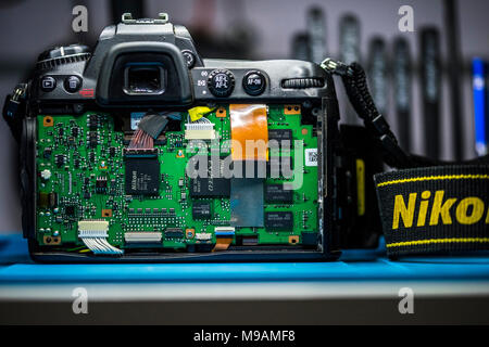 Reparing electronics devices, hands and tools, mobiles and computers. Nion reparing Stock Photo