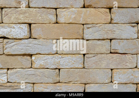 Wall of an old uneven light brick. background Stock Photo