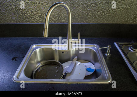 Unwashed dishes in sink close Stock Photo