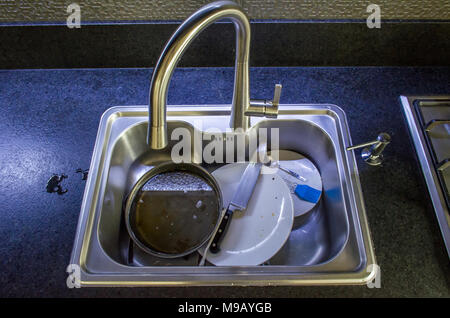Unwashed dishes in sink close Stock Photo