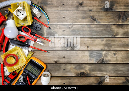 Close-up of work tools and electrical equipment on an antique wooden table with space for text / announcement Stock Photo