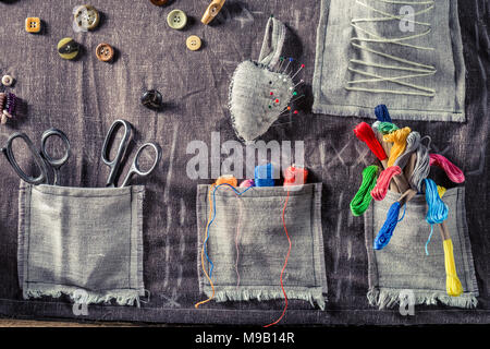 Colored thread, scissors and buttons in tailor mat Stock Photo