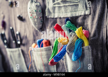 Colored threads, buttons and scissors in the mat tailor Stock Photo