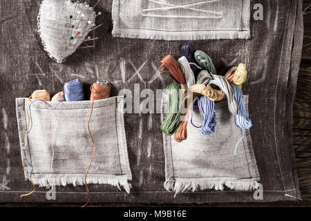 Needles and colored threads in the mat tailor pocket Stock Photo