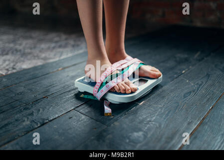 Smart scales with bioelectric impedance analysis, BIA, measuring body fat,  on the background of blurry female legs Stock Photo - Alamy