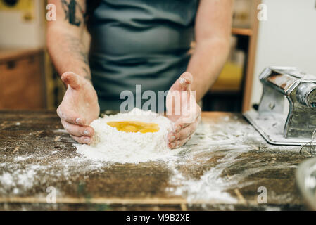 Pasta cooking, bearded chef preparing dough Stock Photo