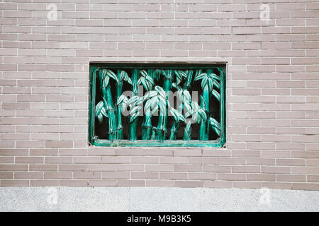 Chinese brick wall and bamboo style window Stock Photo