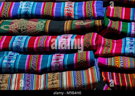 Selection of hand woven costume and textiles for sale laid out on the local sunday market of Tarabuco, Bolivia, South America Stock Photo