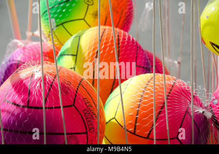 Neoi Poroi, region Pieria, Greece: August 26, 2016: group of colorful balls for kids in net in front of store for sale on bright sunny day Stock Photo