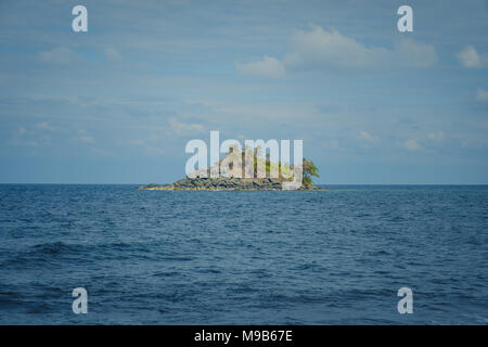 small island isolated in ocean water - tropical island - Stock Photo