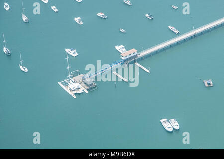 boats on ocean aerial - motorboats and sailing ship at harbor - Stock Photo