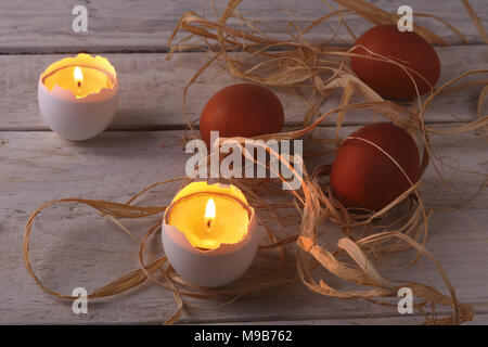 Rustic composition with candles and eggs. Happy easter. Selective focus. Stock Photo