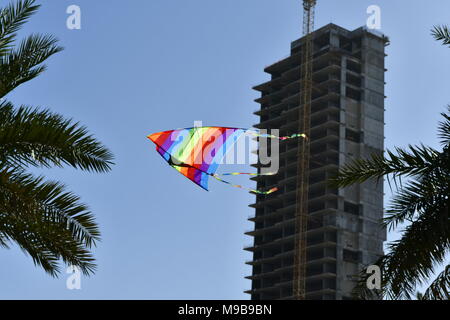 kite in flight in the blue sky near the beachfront Stock Photo