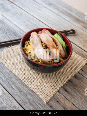 pork noodles in cup on wooden table, Stock Photo