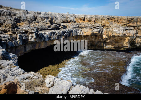 Natural marine cave along rocky shore in Polignano. Apulia, Italy Stock Photo