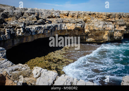 Natural marine cave along rocky shore in Polignano. Apulia, Italy Stock Photo