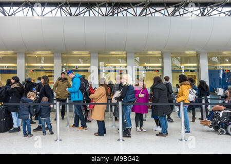 People queue to buy tickets at the ticket office at Reading Railway station in the UK. Stock Photo