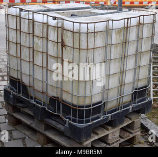 old rainwater tank with a metal frame on a construction site Stock Photo